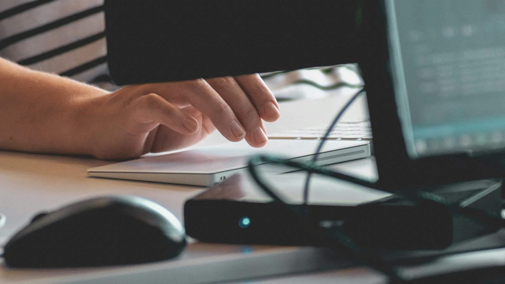 person using computer on table